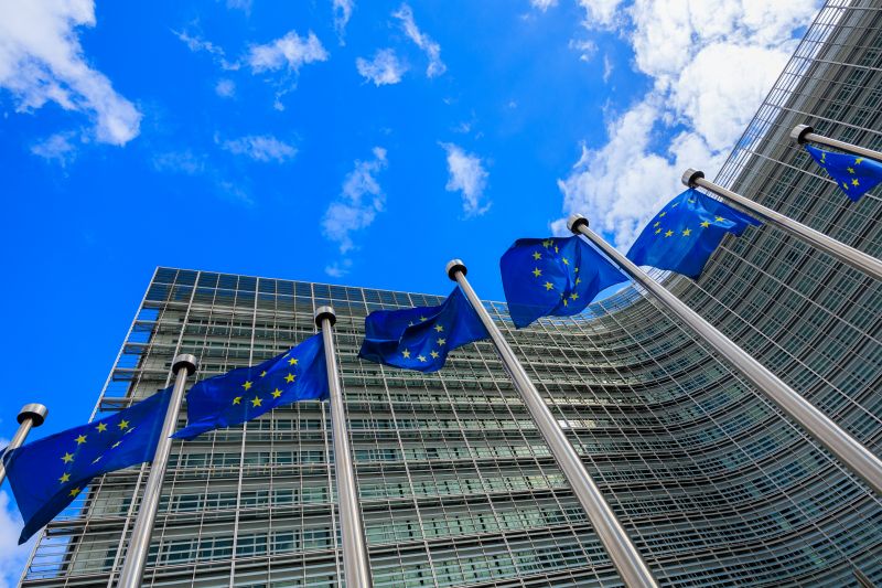 Image of flags outside the European Commission’s headquarters in the Berlaymont building in Brussels, Belgium. Credit: Shutterstock